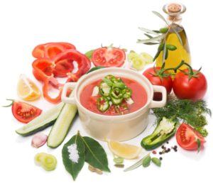 Schale Gazpacho, darum die Zutaten Tomaten, Gurken, Paprika, Öl und Kräuter.